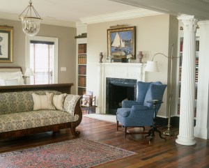 Franck created a tranquil master bedroom with views of the water and a classically styled fireplace. She reupholstered Davis's Biedermeyer sofa in a durable Schumacher fabric as a counterbalance to its formality.