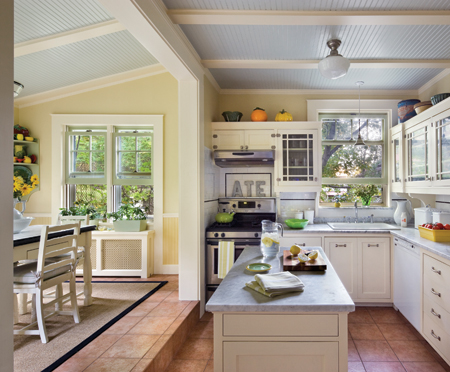 In three phases, the kitchen was transformed from busy 1970s to 1940s. Brewer retained the original cabinet boxes, which were painted white and fitted with new doors, trim and brackets. The wainscot, casing, island, built-in pantry and cabinet, and appliances are also new. Photo: © Francis Dzikowski / Esto 